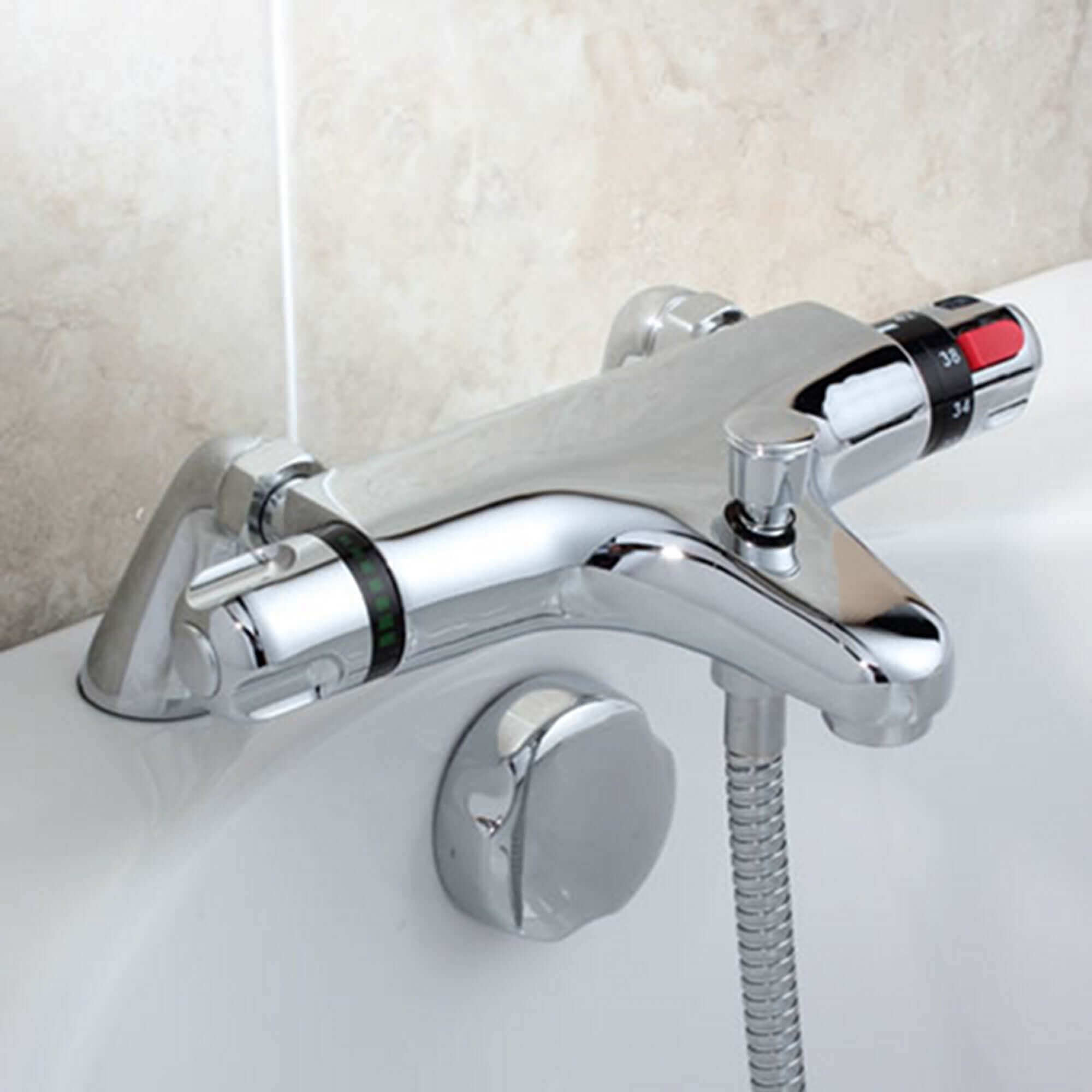 Chrome thermostatic bath shower mixer tap with temperature control and sleek design, installed on a bathtub